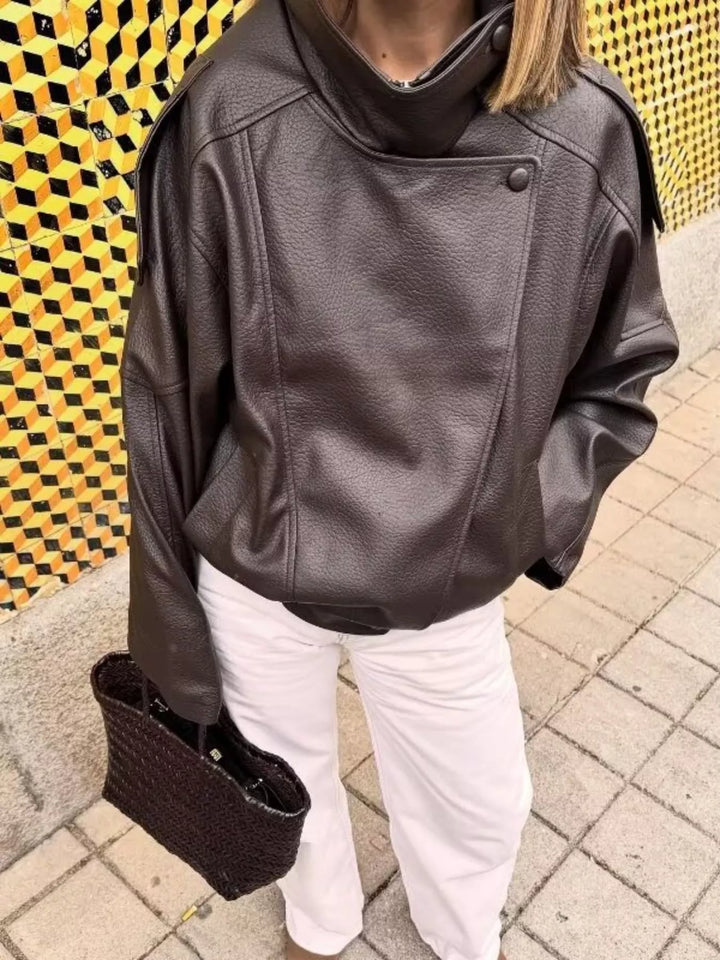 Chocolate oversized moto jacket styled with white pants and a woven bag