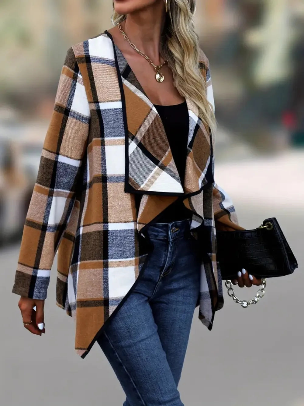 Caramel plaid fall jacket with draped front, carried with a small black handbag