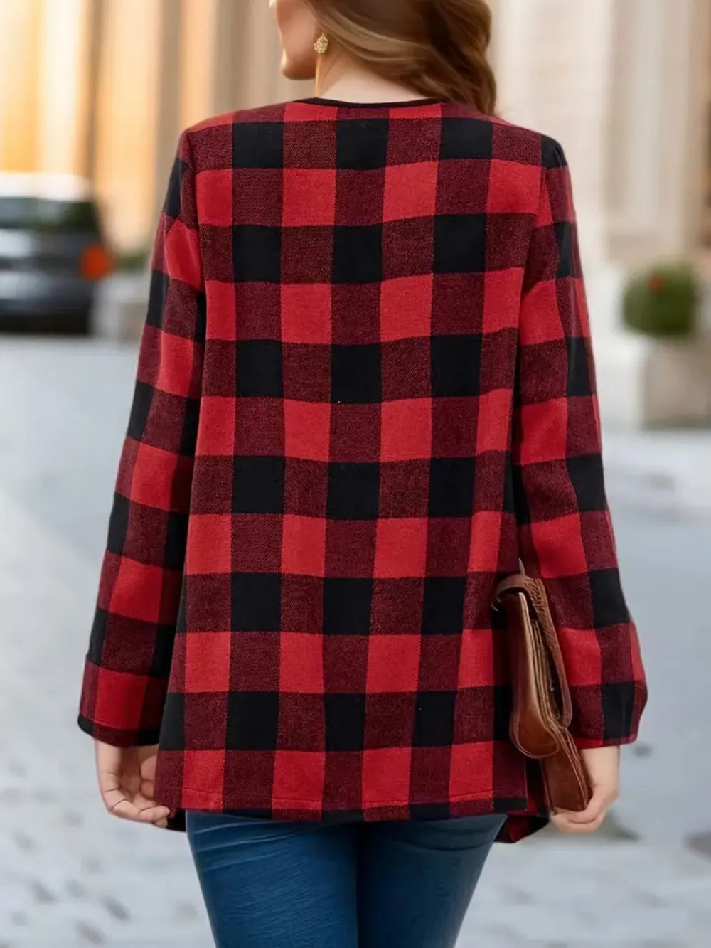 Back view of the red plaid fall jacket worn with jeans and a clutch