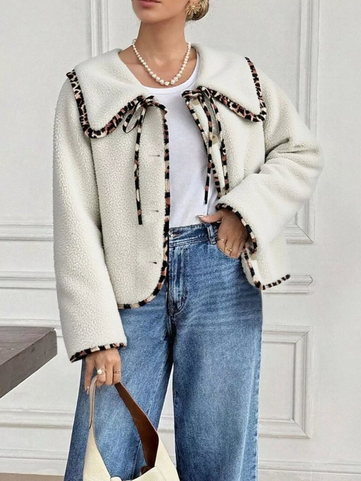 Women's fall jacket in cream with plush Peter Pan collar and leopard trim, worn with jeans