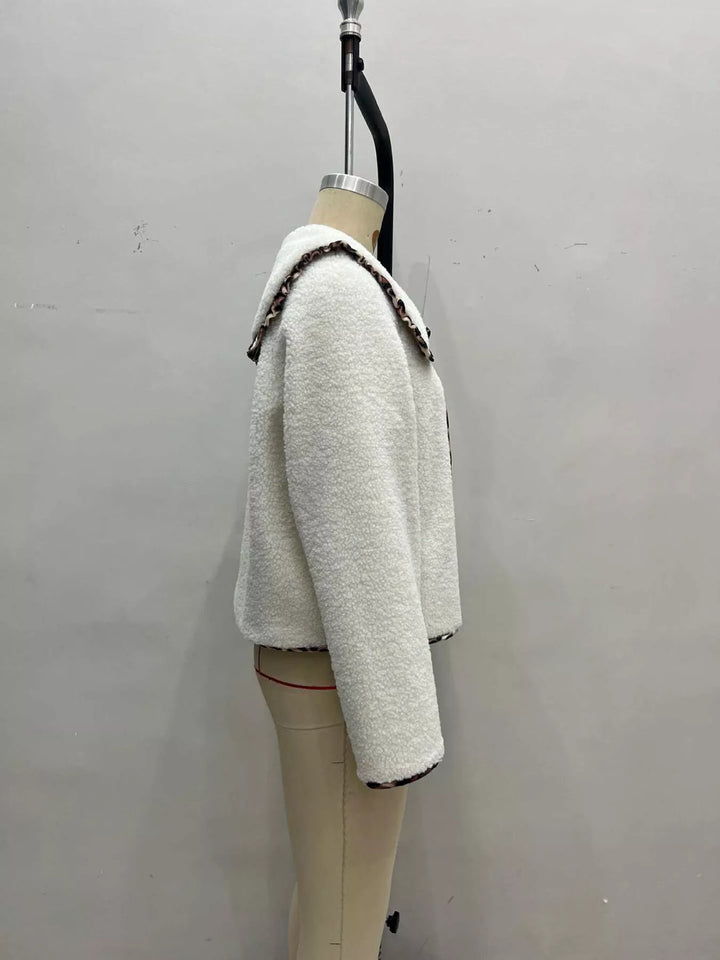 Side view of cream plush fall jacket with leopard trim collar on a mannequin