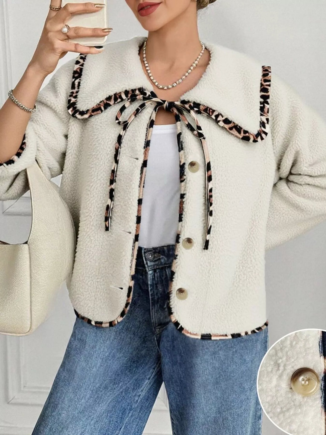 Cream plush jacket with leopard trim tie neck, styled with a white tank and jeans