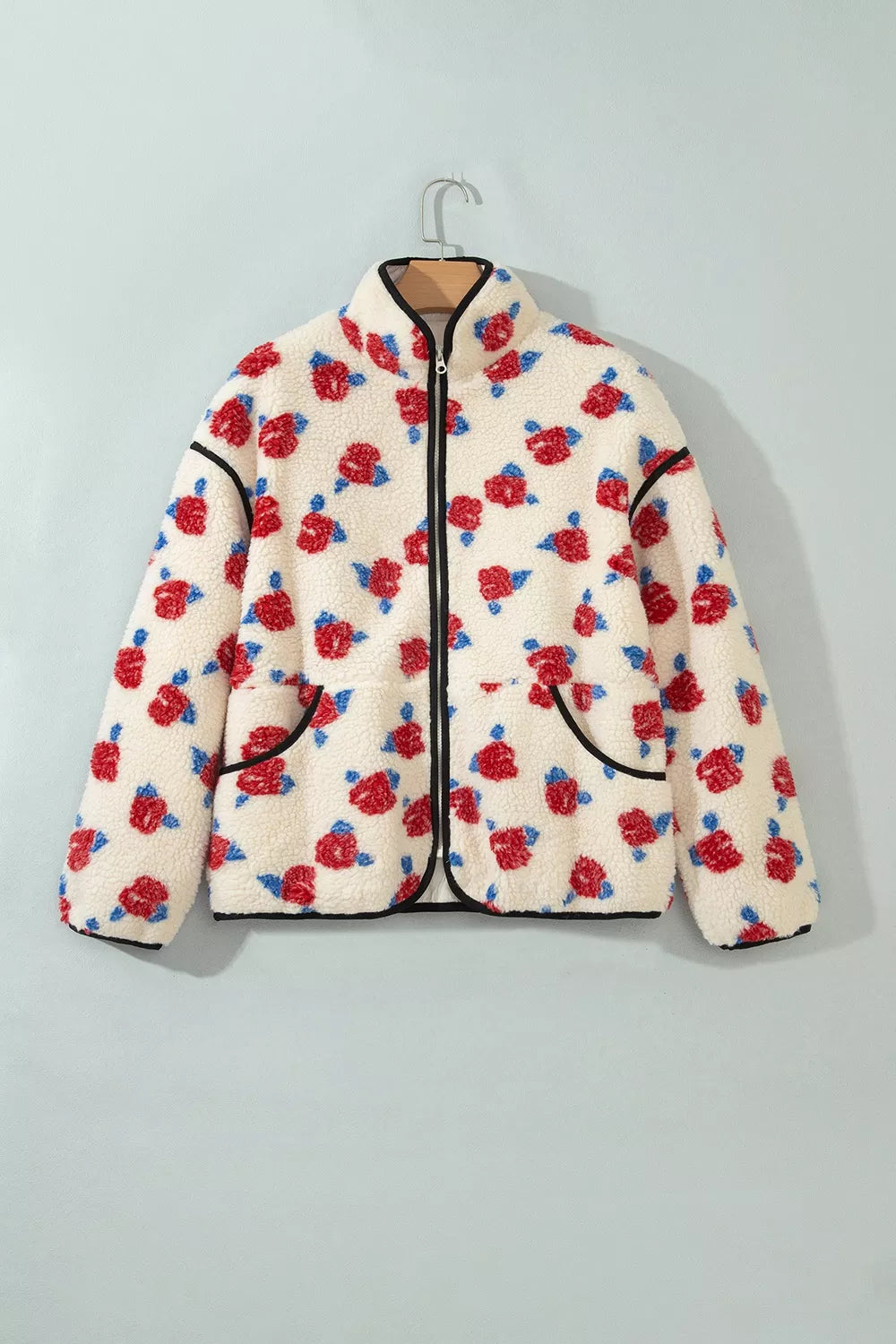 Cream floral rose print jacket on a hanger, front view