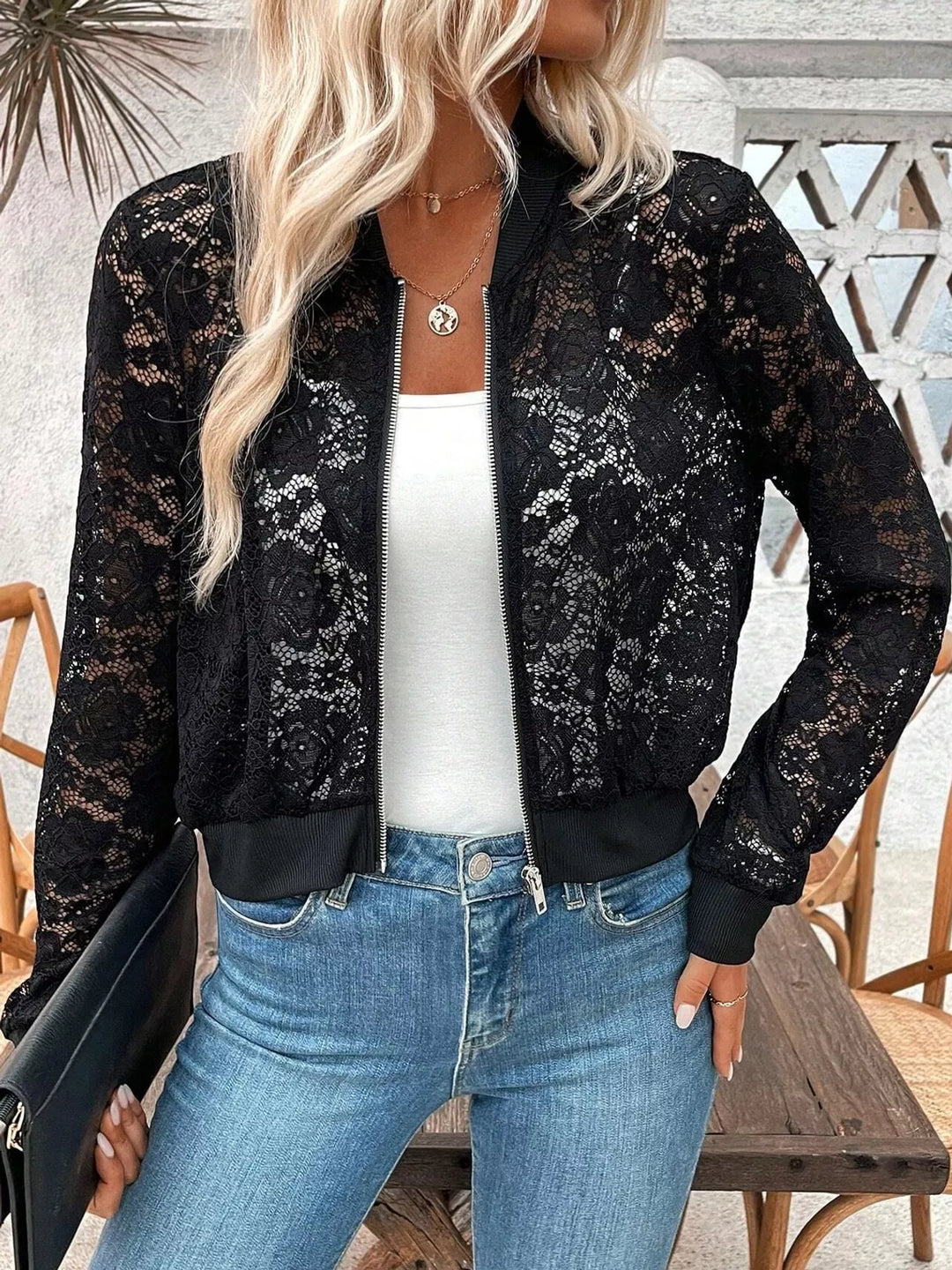 Sheer floral lace cropped zip-up bomber in black, styled on model 2