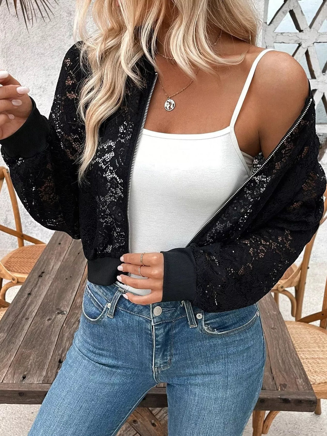 Sheer floral lace cropped zip-up bomber in black, styled on model