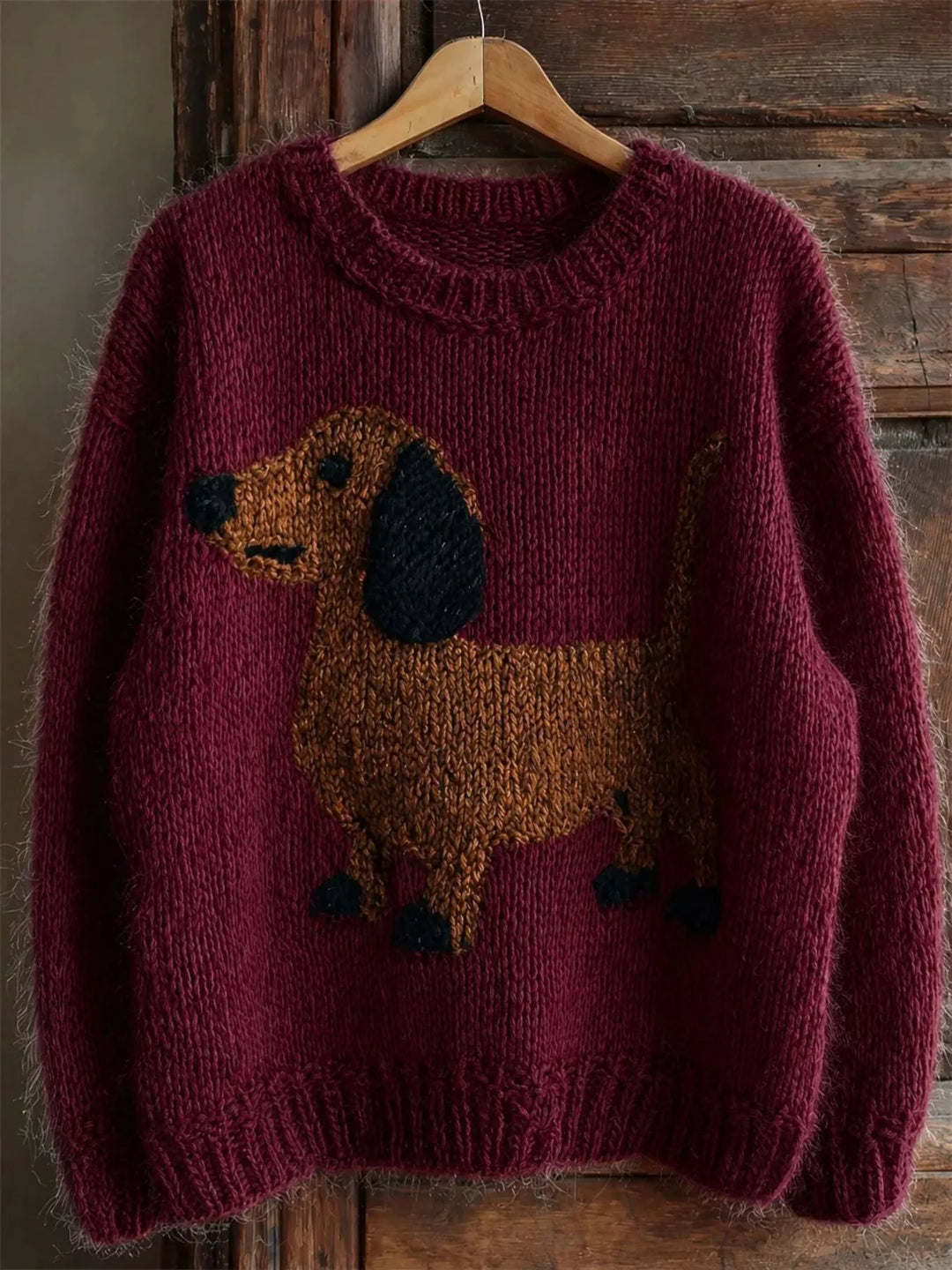 Burgundy chunky knit crew neck sweater with a dachshund design, front view
