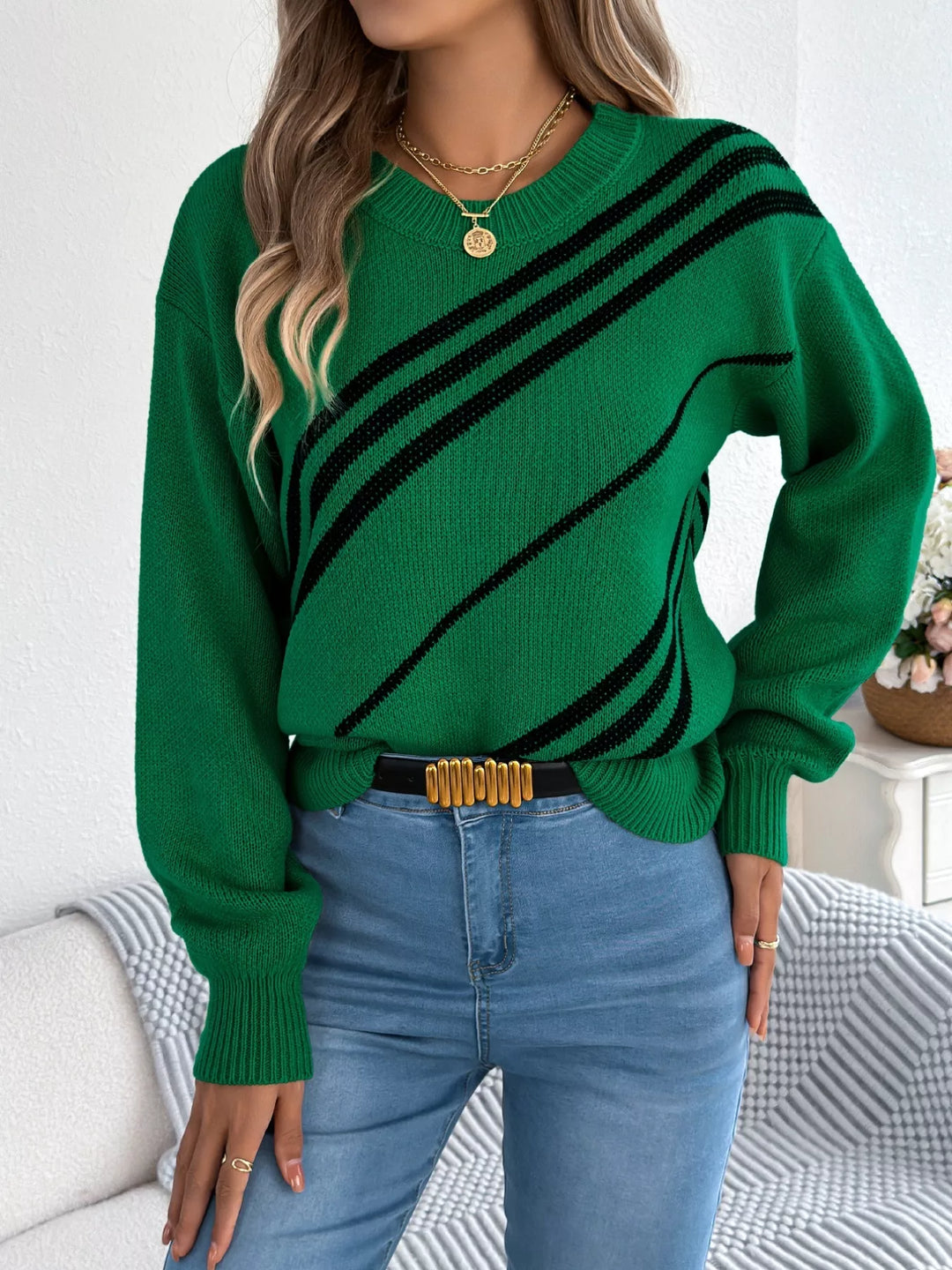 Emerald green striped sweater front view with belt and jeans