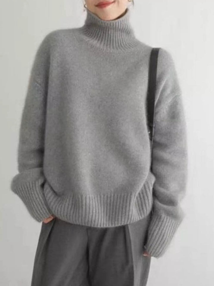 Gray fall sweater worn with charcoal trousers, relaxed front view