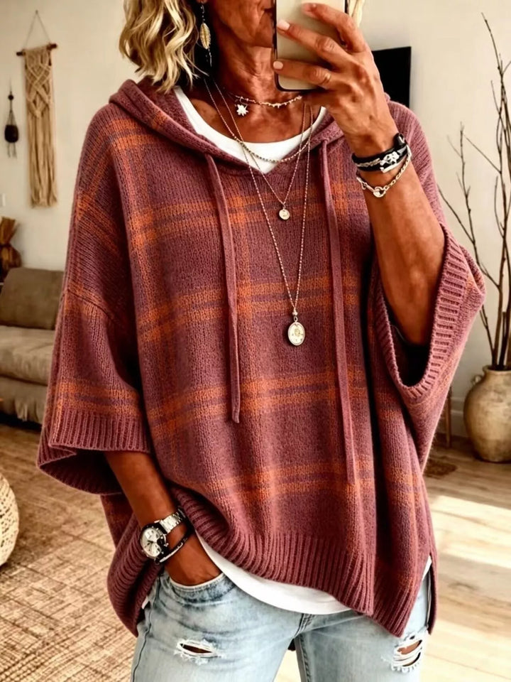 Brick red plaid hooded sweater with relaxed batwing sleeves, front view