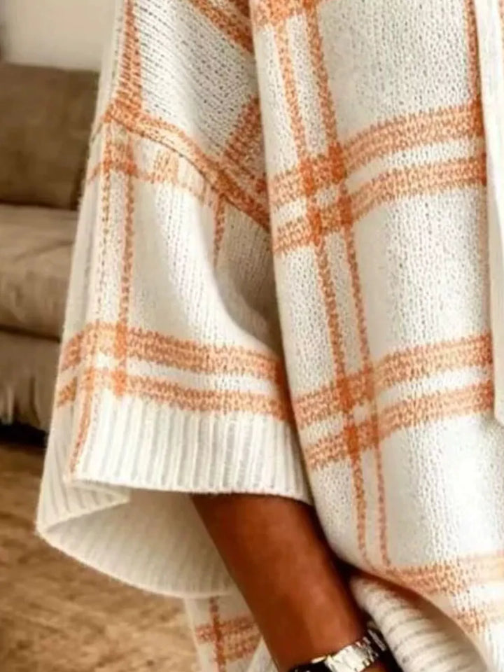 Close-up of the cream plaid knit pattern on the batwing sleeve