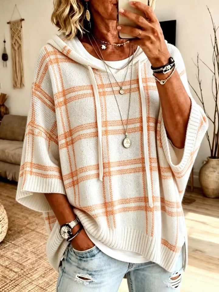 Cream plaid hooded pullover with orange check pattern and batwing sleeves