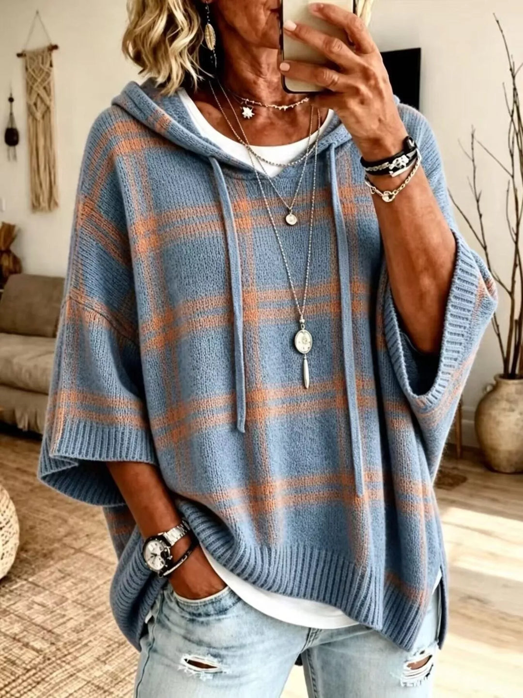 Dusty blue plaid hooded sweater with relaxed batwing fit, styled with jeans