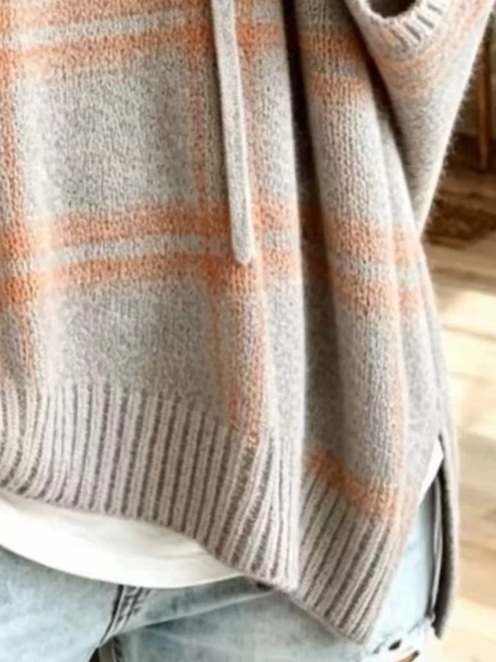 Close-up of the heather gray plaid knit with ribbed side slit hem