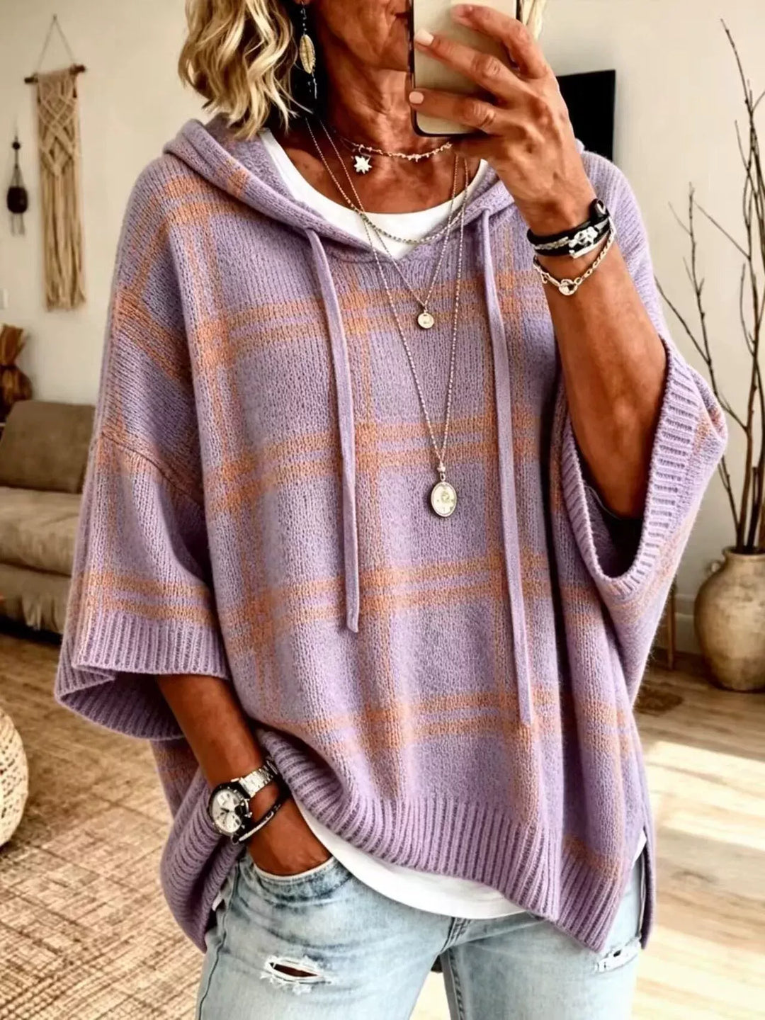 Lavender plaid batwing pullover layered over a white top, front view