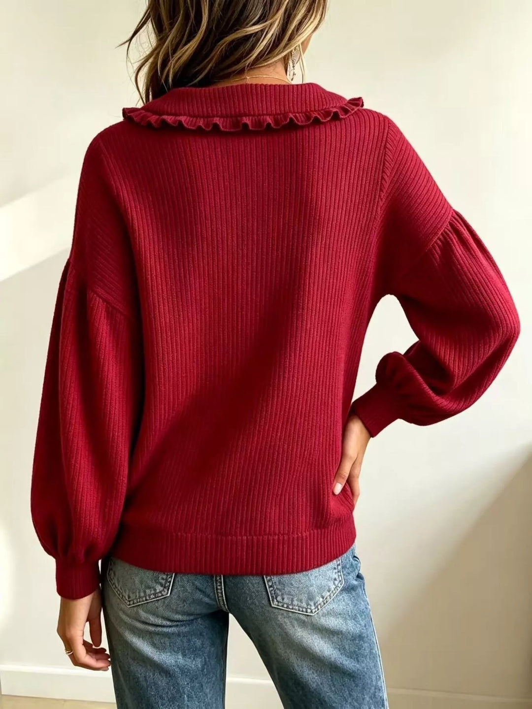 Back view of red ribbed knit sweater with puff sleeves