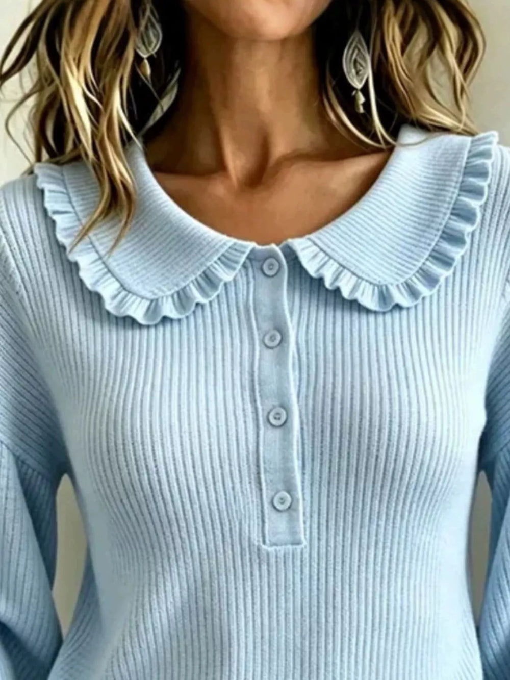 Close-up of sky blue sweater ruffle collar and button placket