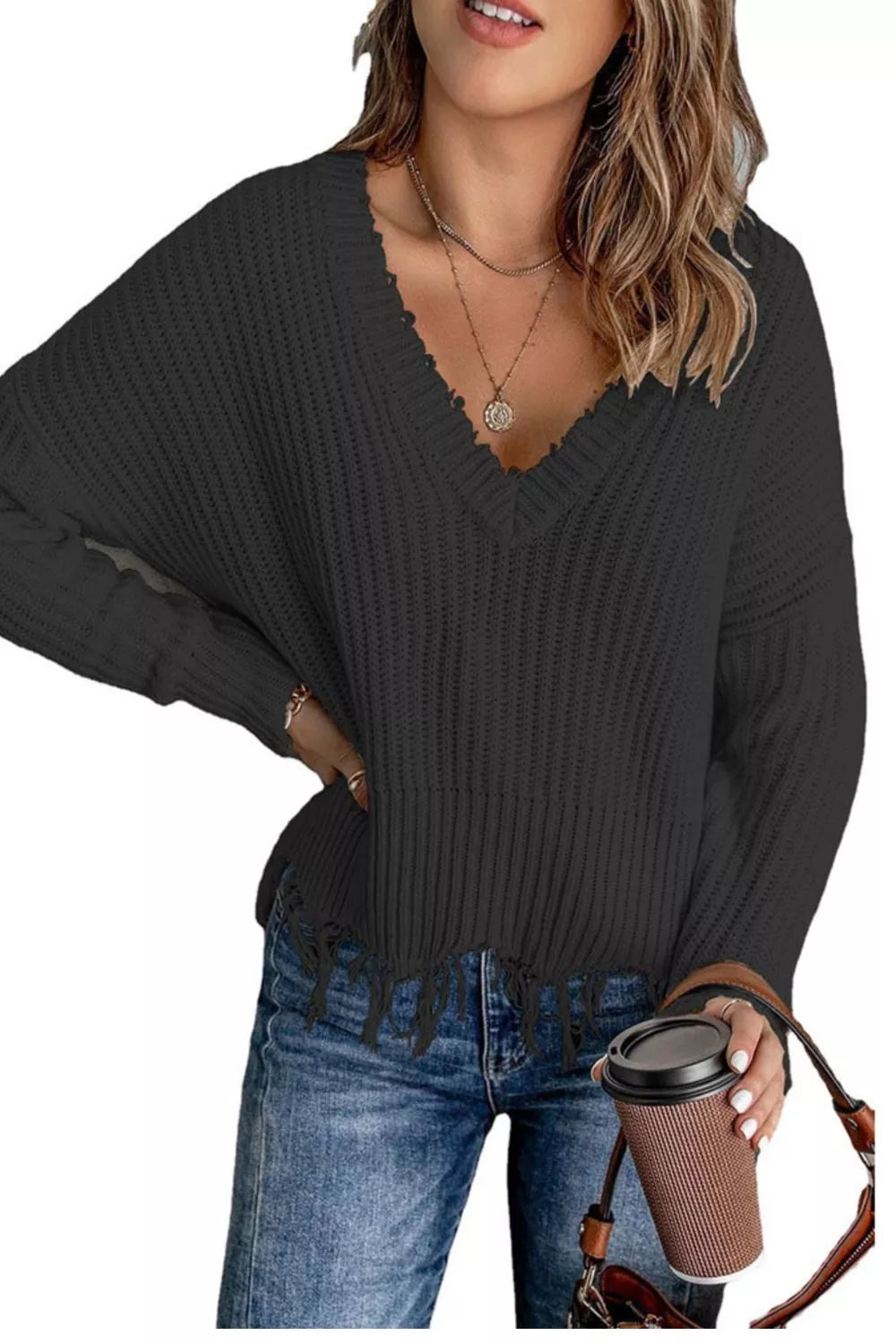 Black v-neck ribbed sweater with hand on hip and frayed hem
