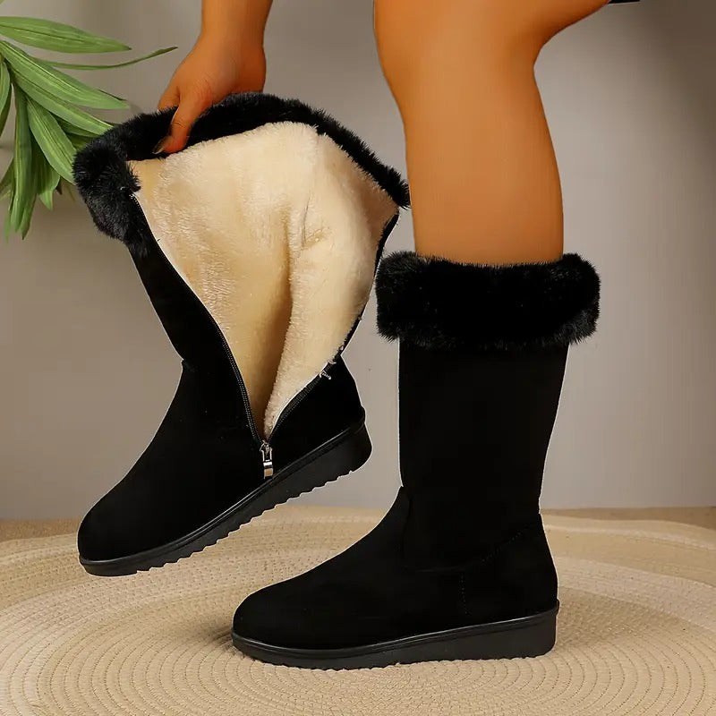Black winter boot opened at the side zip showing the plush lining