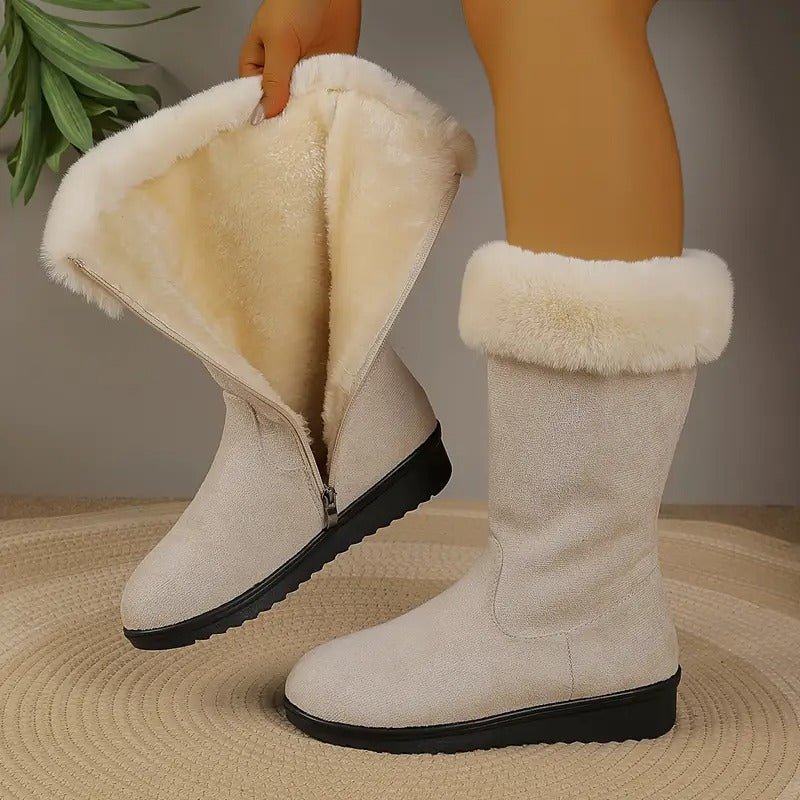 Cream winter boot unzipped to show the soft plush interior