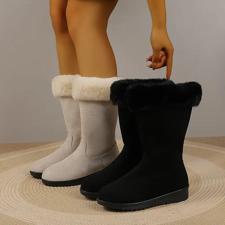 Cream and black faux fur boots worn side by side