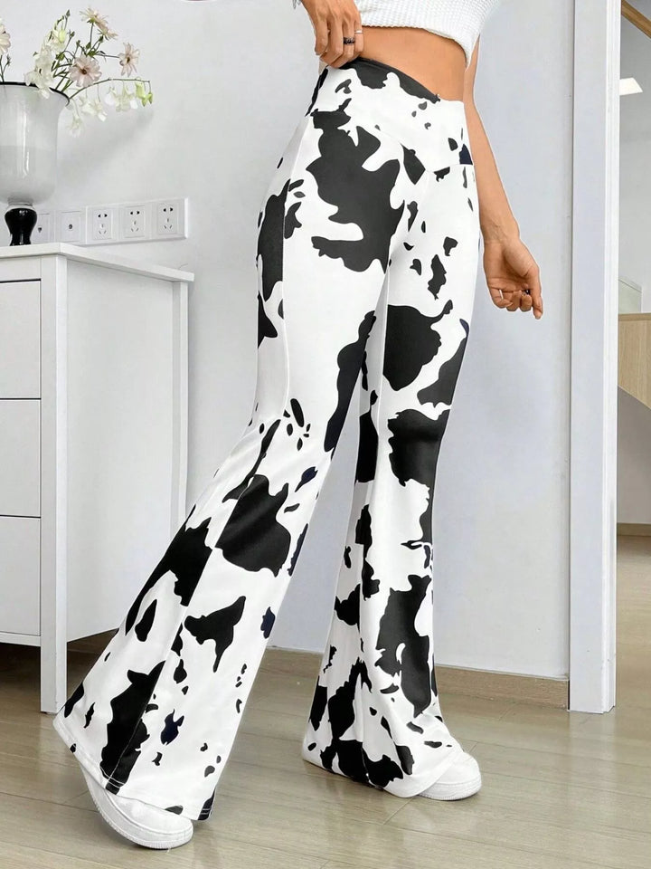 Women's flare pants in black and white cow print with high waist, front view