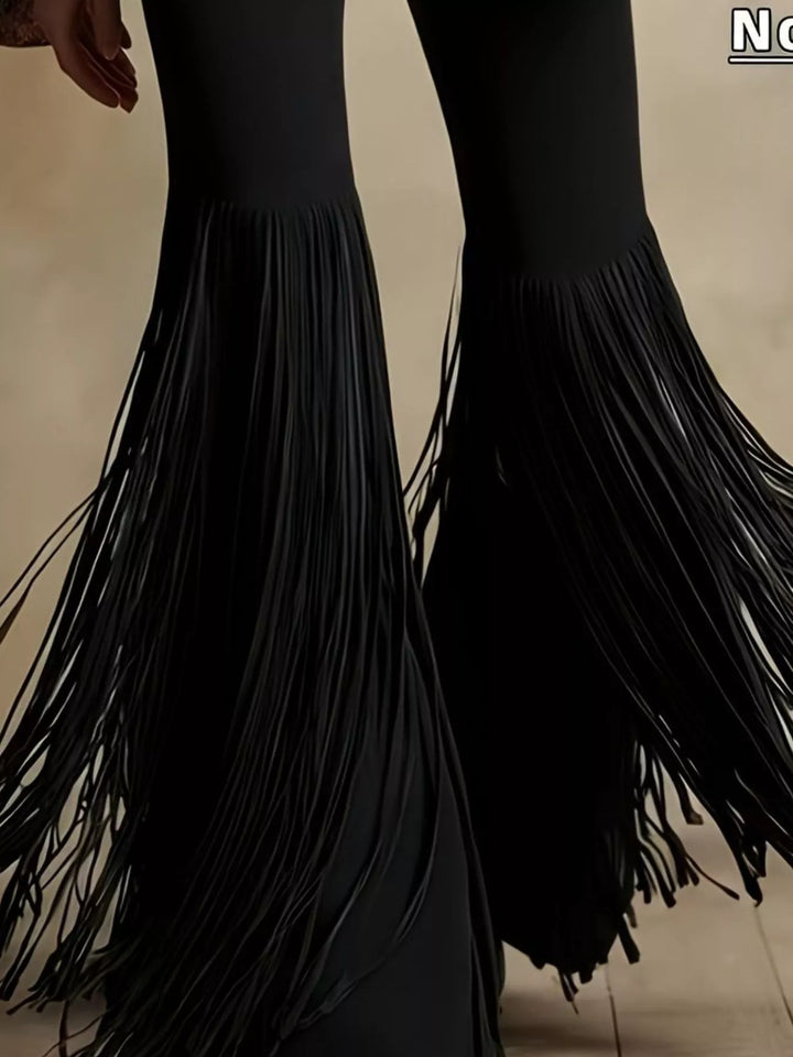 Close-up of the long fringe on the black western style flare pants