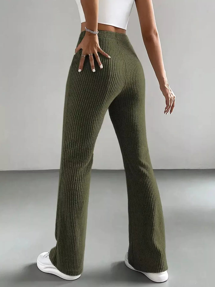 Back view of olive green high waisted flare pants with hand on hip