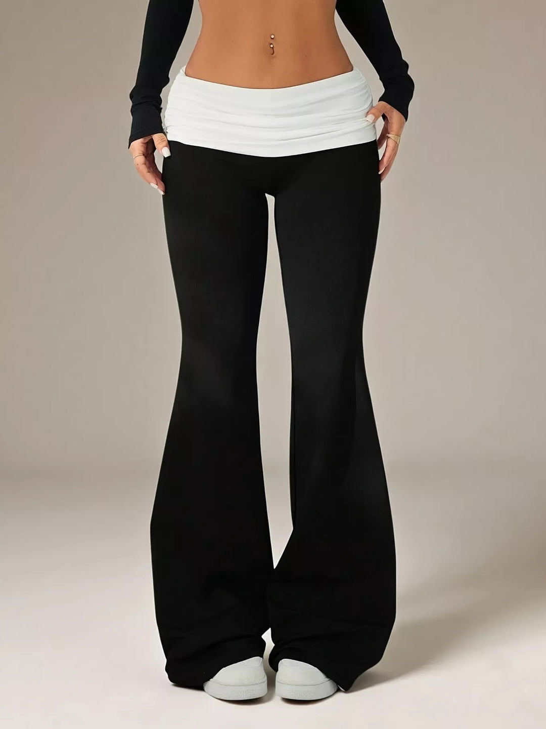 Black flare pants with a white fold over waistband, front view