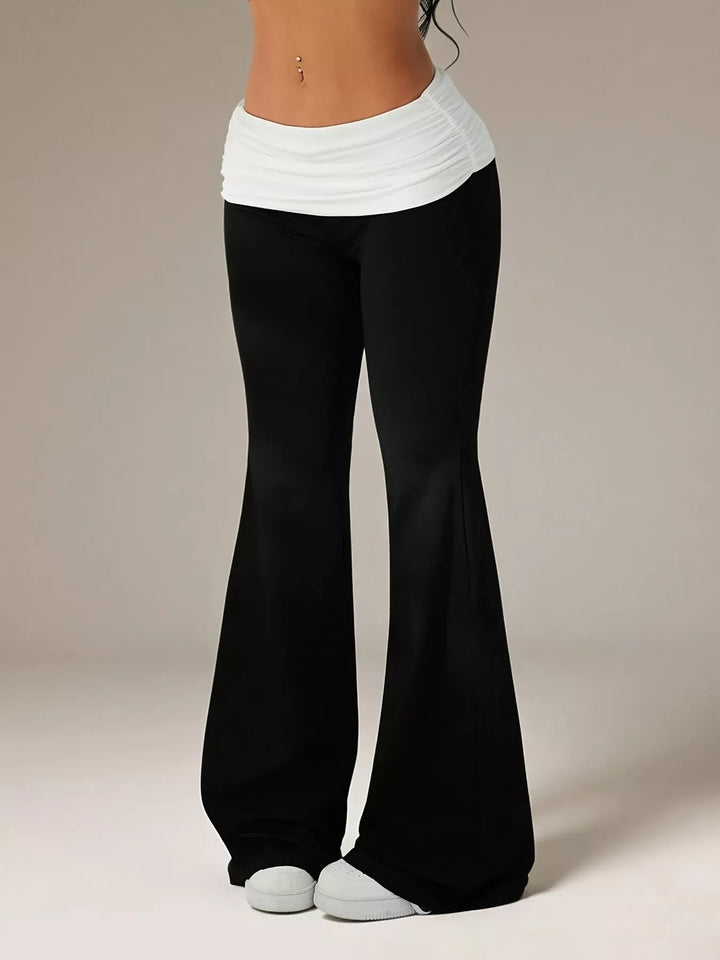 Full-length black and white flare pants with a slim thigh and wide flared hem