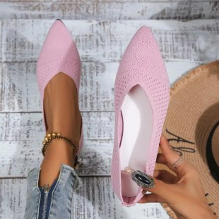 Pink knit slip on flat held up to show the inside lining