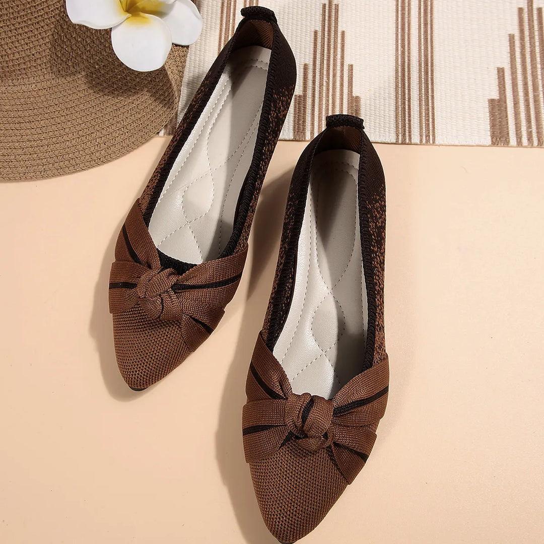 Brown slip on flats with knotted bow shown from above