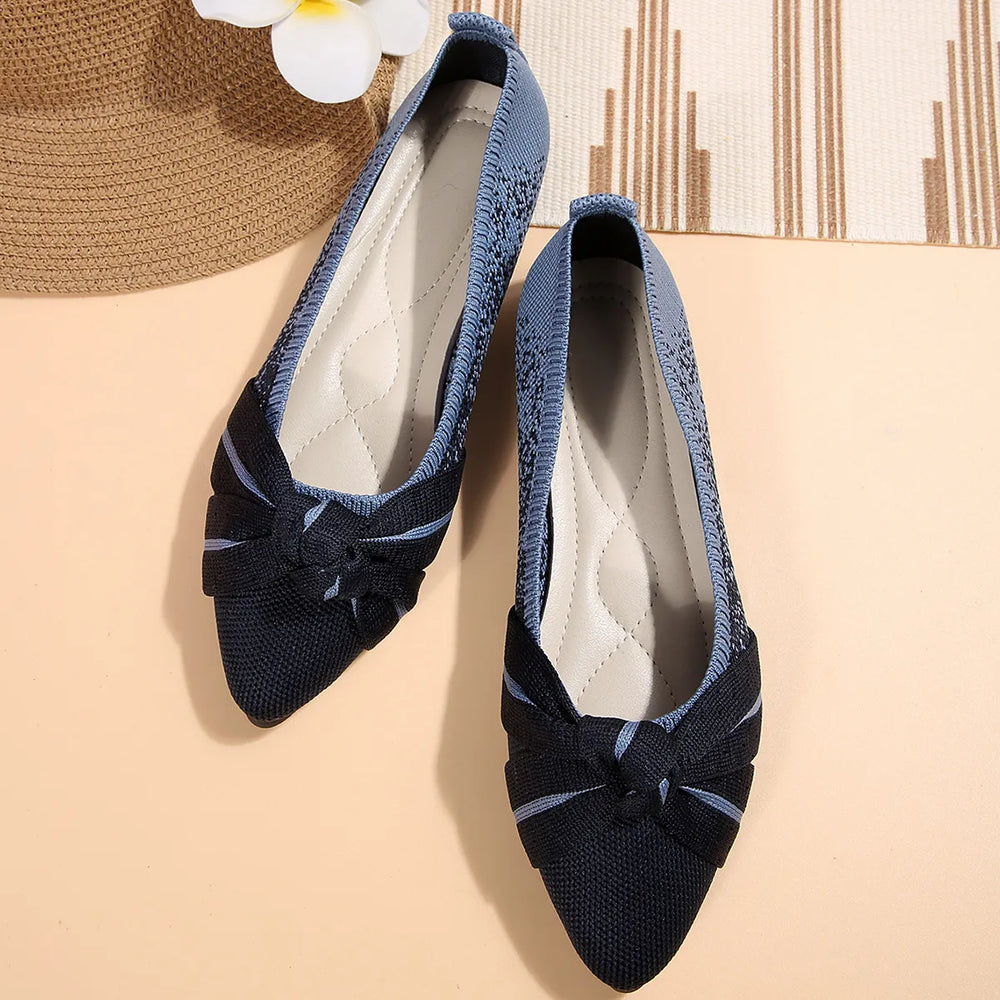 Navy pointed toe slip on flats with knotted bow, top view of the pair