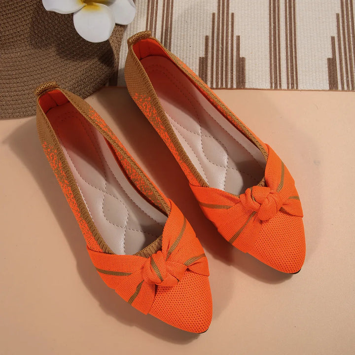 Orange slip on flats with a knotted bow and pointed toe
