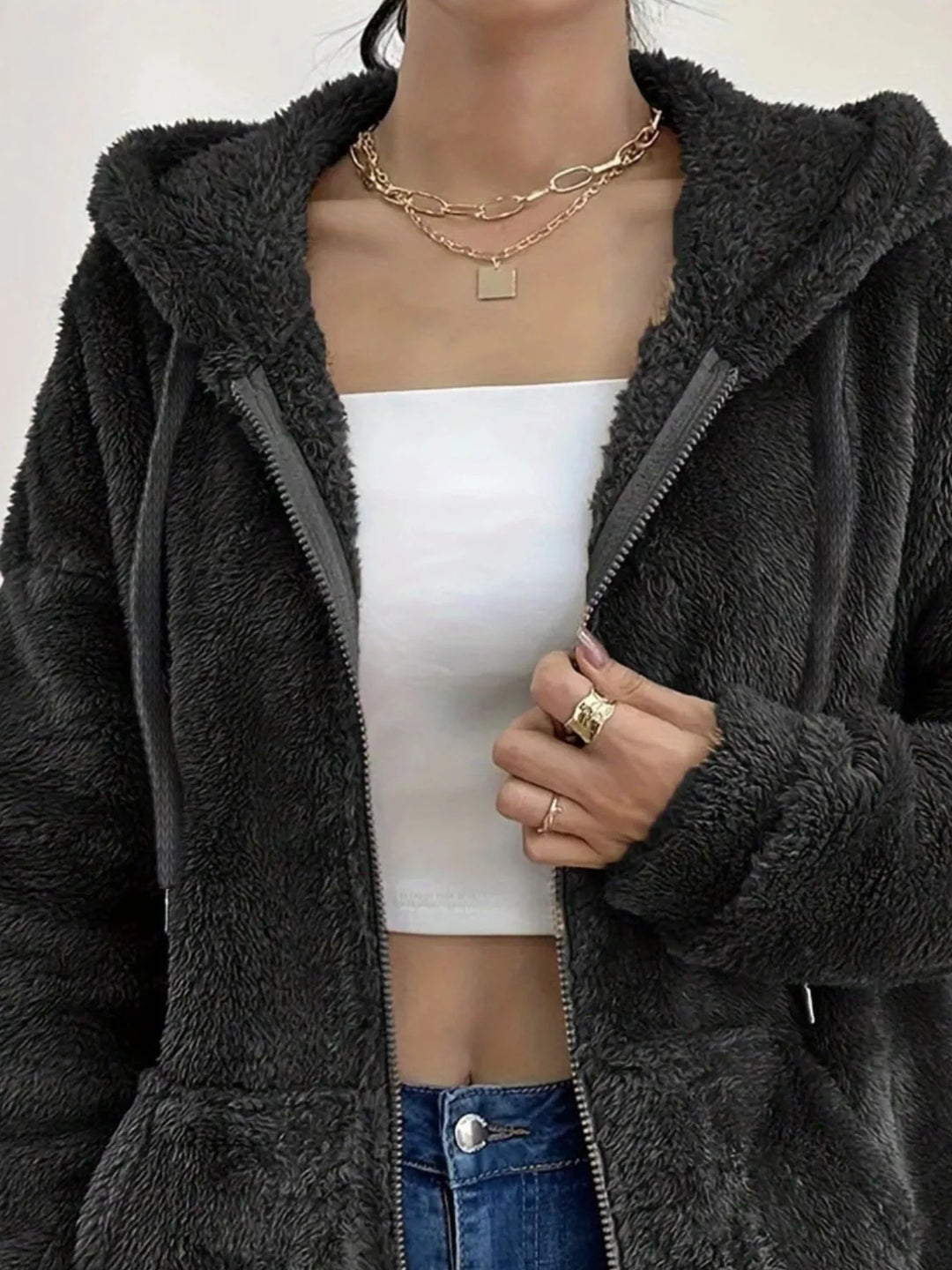 Close-up of black fleece jacket open zip front and hood drawstring