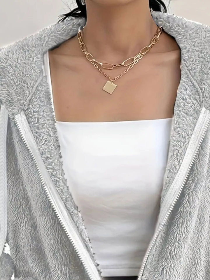 Close-up of light gray fleece jacket open zip front and hood drawstring