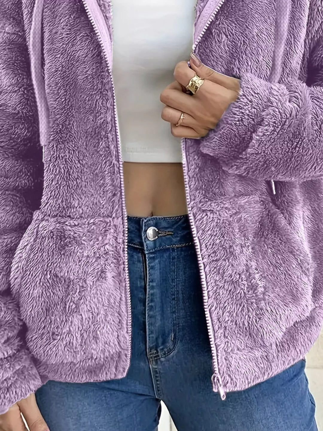 Lilac fleece jacket pocket and sleeve texture, close-up with zipper