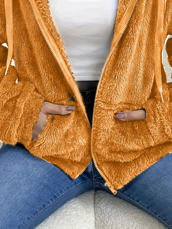 Close-up of orange fleece jacket open zip front and hood drawstring
