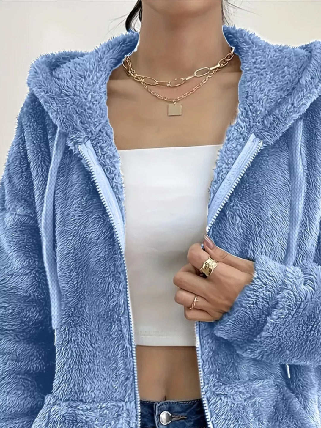 Close-up of sky blue fleece jacket open zip front and hood drawstring