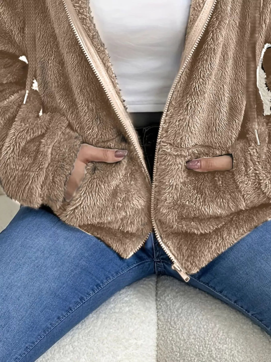 Close-up of taupe fleece jacket open zip front and hood drawstring
