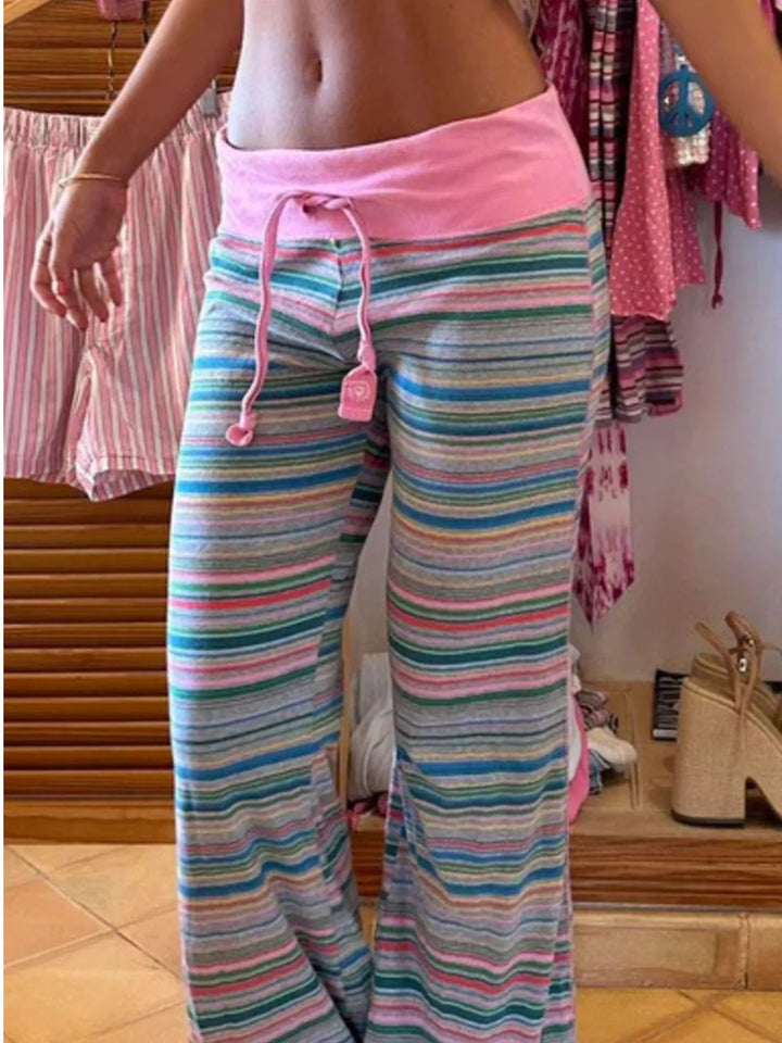 Striped knit flare lounge pants with drawstring tassels, worn with a cropped top