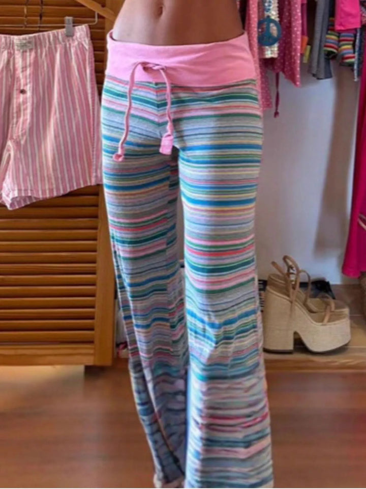Full length view of striped flare lounge pants on a wood floor
