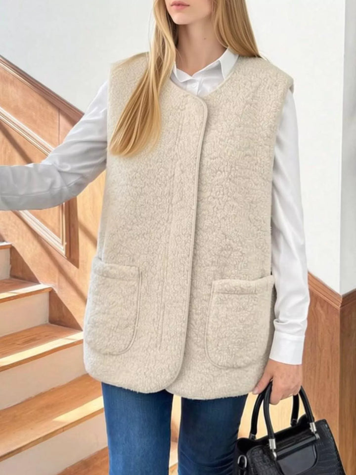 Women's fuzzy vest in beige with a round neck and patch pockets