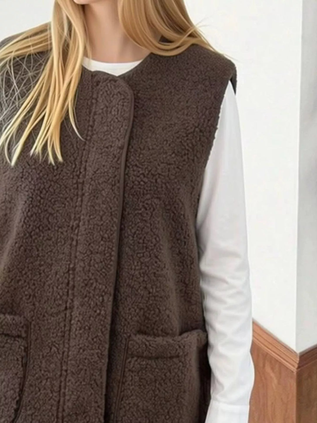 Close-up of the coffee brown fuzzy vest texture and pocket