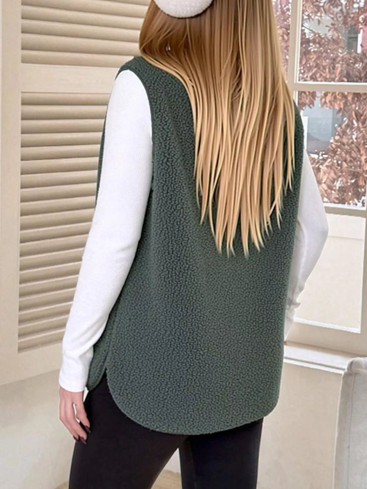 Back view of the forest green fuzzy vest with a curved hem