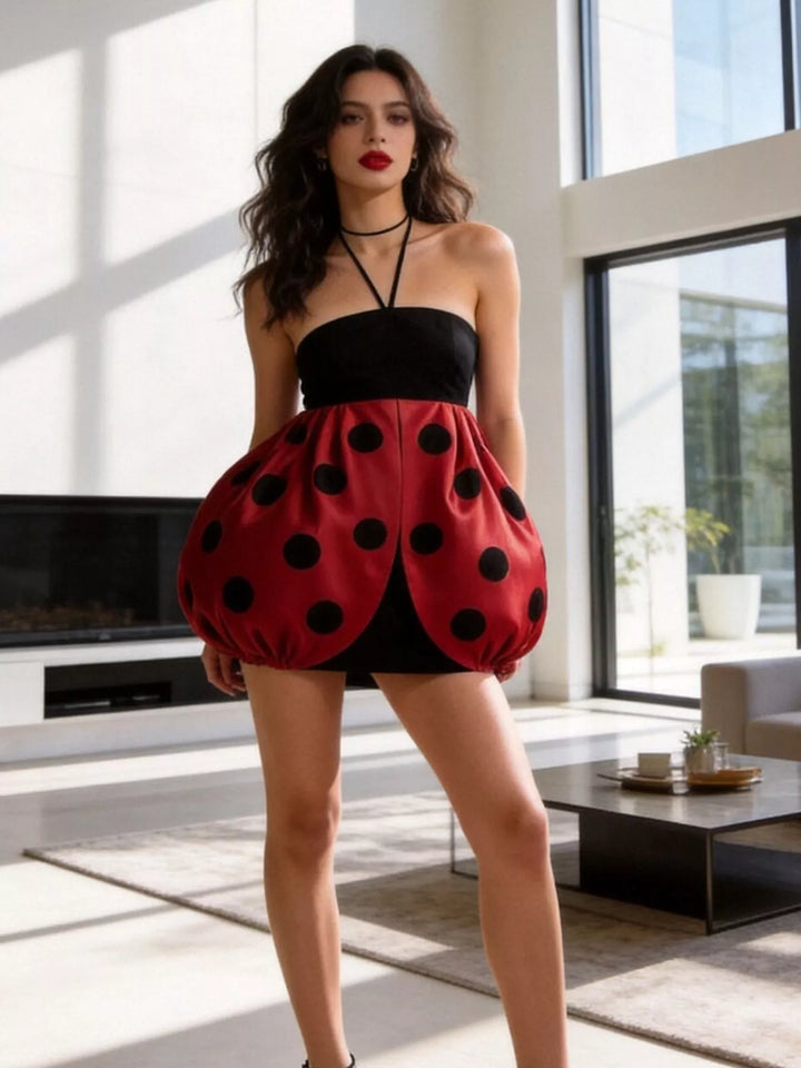 Deep red mini dress worn on a model, showing the bubble skirt from another angle 2