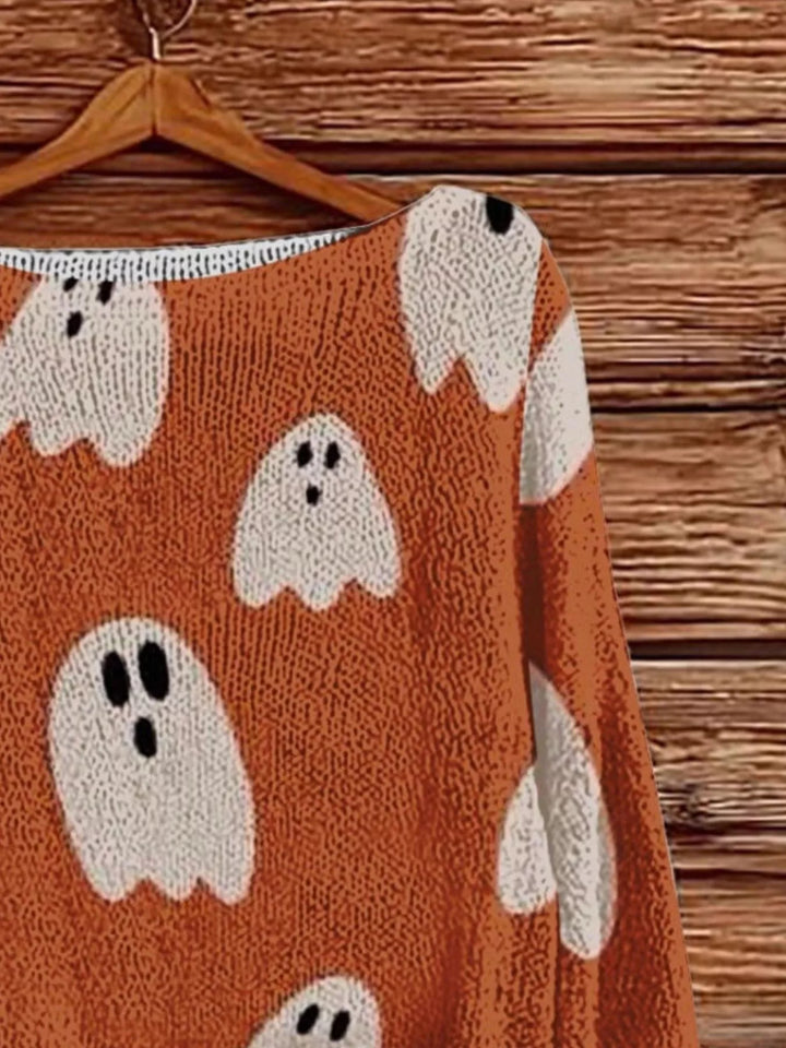 Close-up of orange boat neck sweater with white ghost pattern