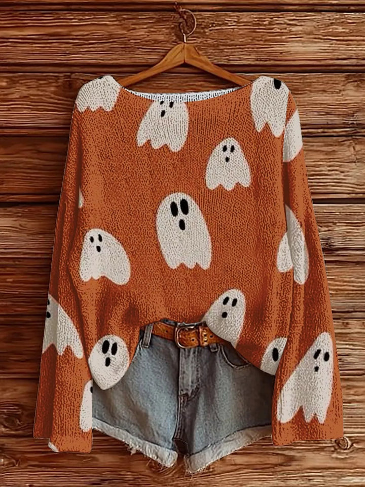 Orange Halloween sweater with white ghost print hanging with denim shorts