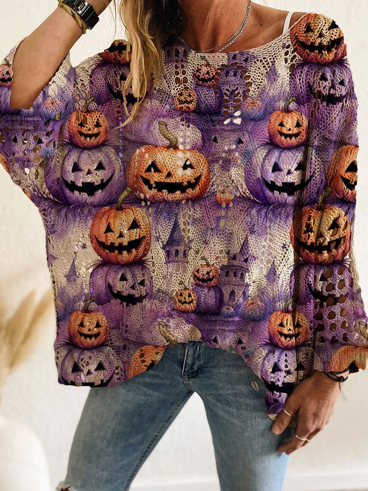 Purple oversized Halloween sweater covered in pumpkin and castle print