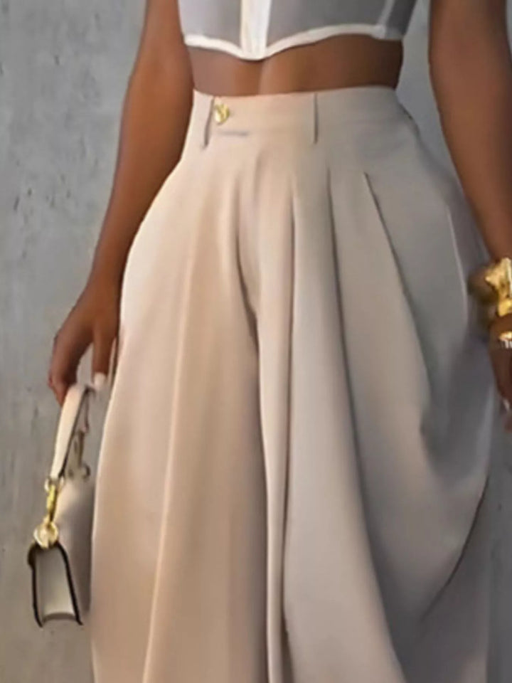Close-up of the beige harem pants pleated front and gold waist button