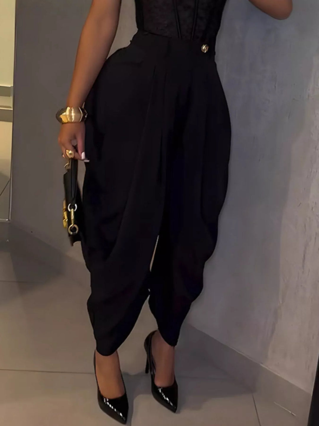Black harem pants side view with draped wrapped hem and glossy heels